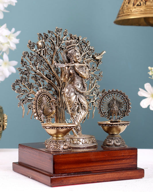 Brass Superfine Lord Krishna with Kalpavriksha & Twin Peacock Lamps on Wooden Base – Decorative Gift Piece (8 Inches) - Budhshiv.com