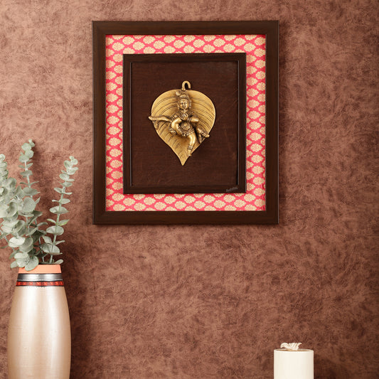 Brass Baby Krishna Baal Gopal Resting on a Leaf Hanging on Wooden Frame with Premium Fabric - 13" x 14"