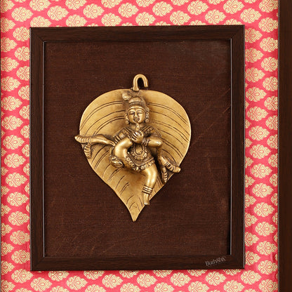 Brass Baby Krishna Baal Gopal Resting on a Leaf Hanging on Wooden Frame with Premium Fabric - 13" x 14"