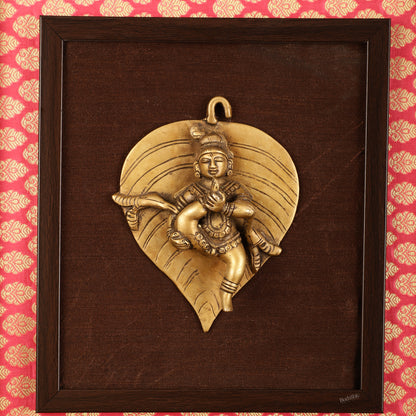 Brass Baby Krishna Baal Gopal Resting on a Leaf Hanging on Wooden Frame with Premium Fabric - 13" x 14"