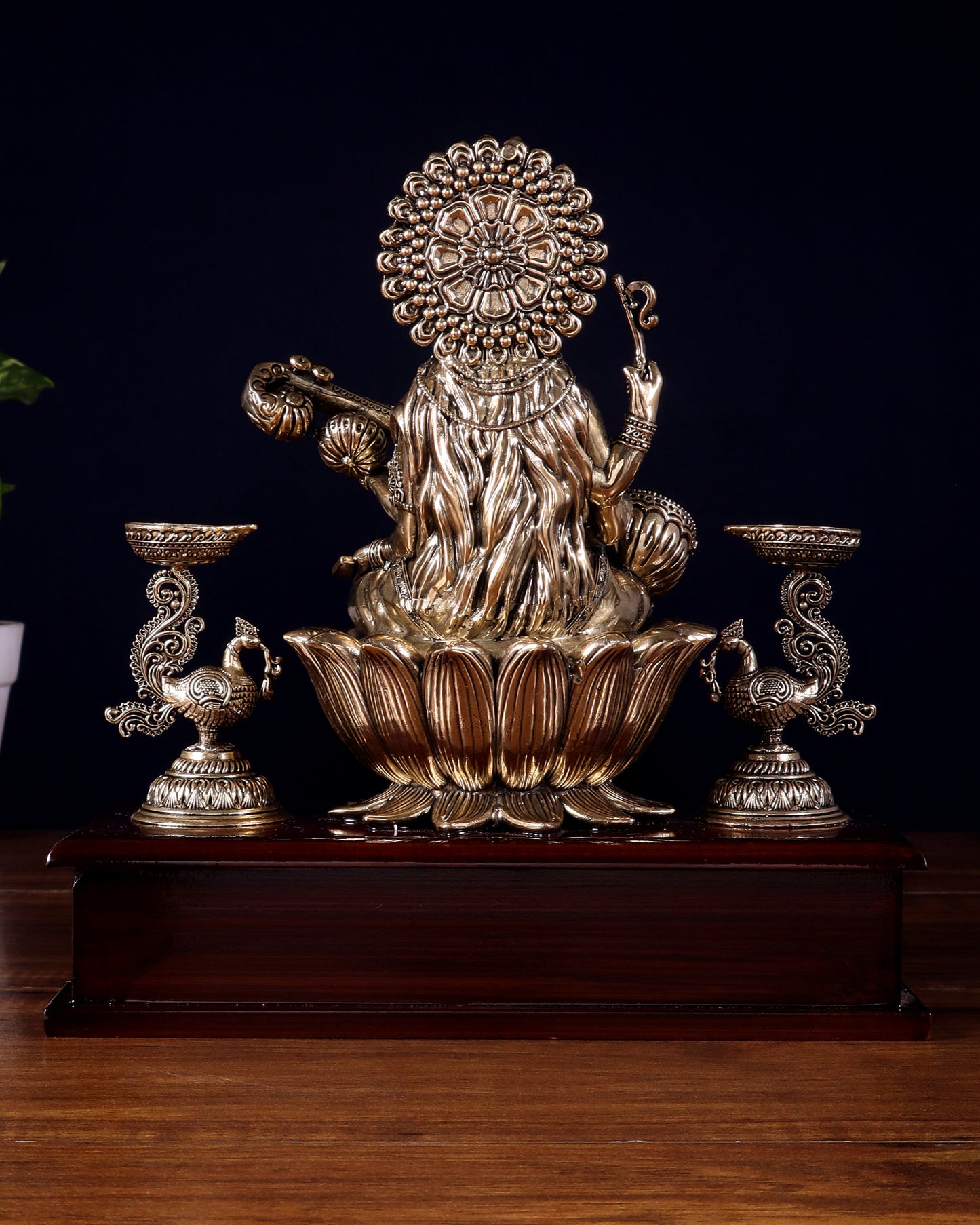 Brass Superfine Goddess Saraswati Idol with Twin Peacock Lamps on Wooden Base – 9.5 Inch