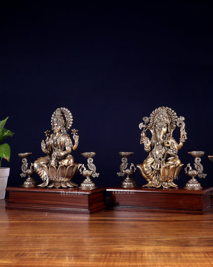 Brass Superfine Ganesh–Lakshmi Pair with Twin Peacock Lamps on Wooden Base – 9.5 Inch