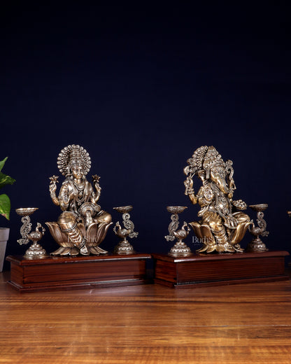 Brass Superfine Ganesh–Lakshmi Pair with Twin Peacock Lamps on Wooden Base – 9.5 Inch