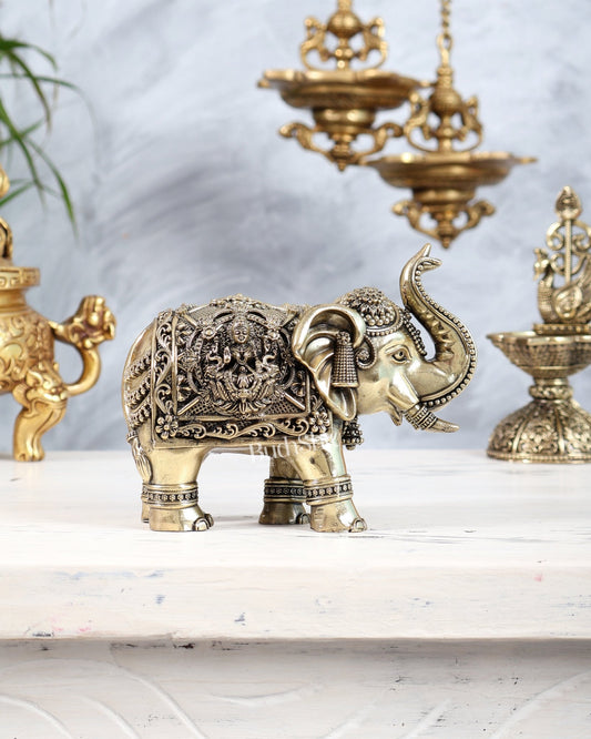 Brass Elephant Showpiece Trunk Up with Ganesha Lakshmi Carvings | Auspicious Décor Figurine 6" wide - Budhshiv.com