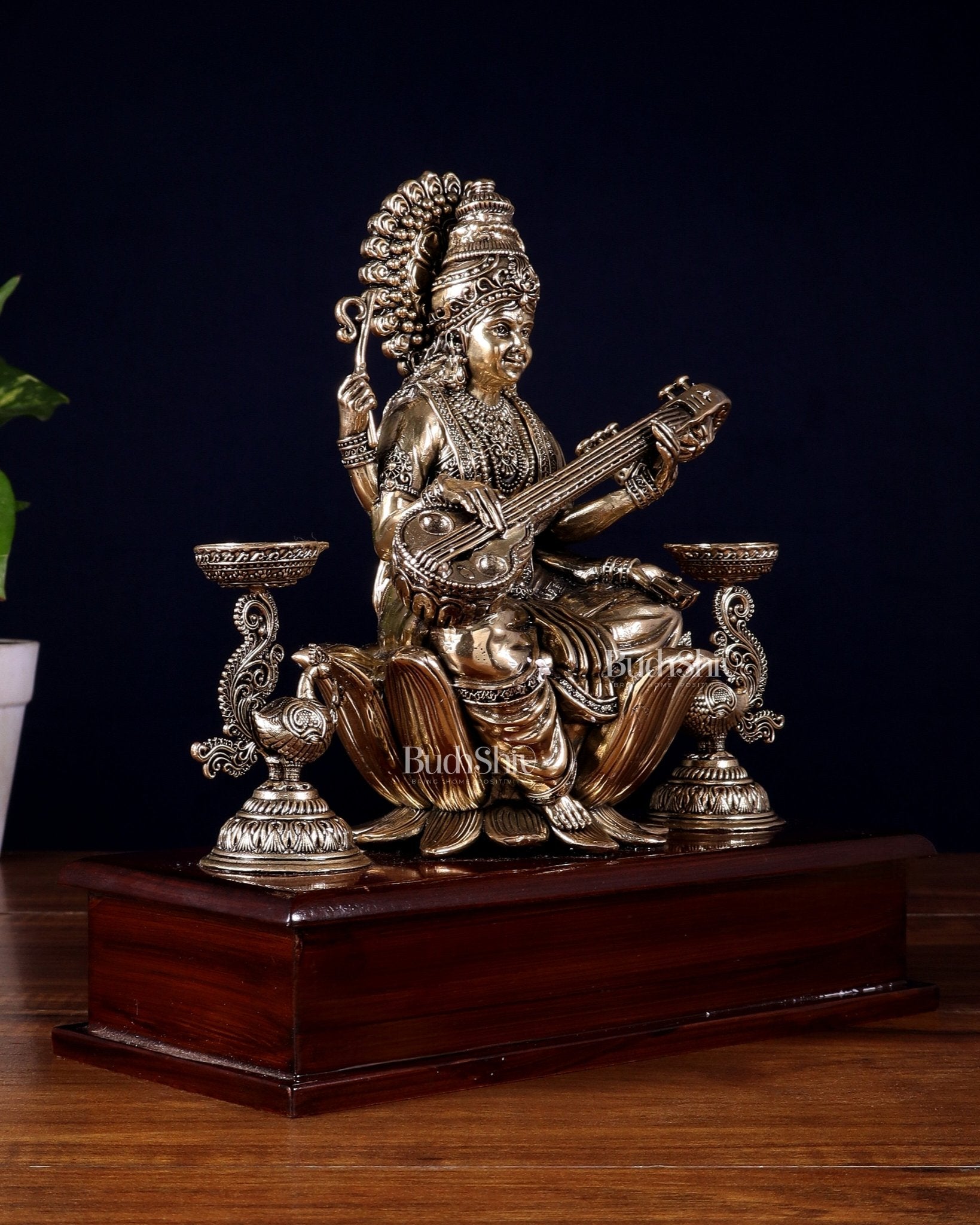 Brass Superfine Goddess Saraswati Idol with Twin Peacock Lamps on Wooden Base – 9.5 Inch - Budhshiv.com