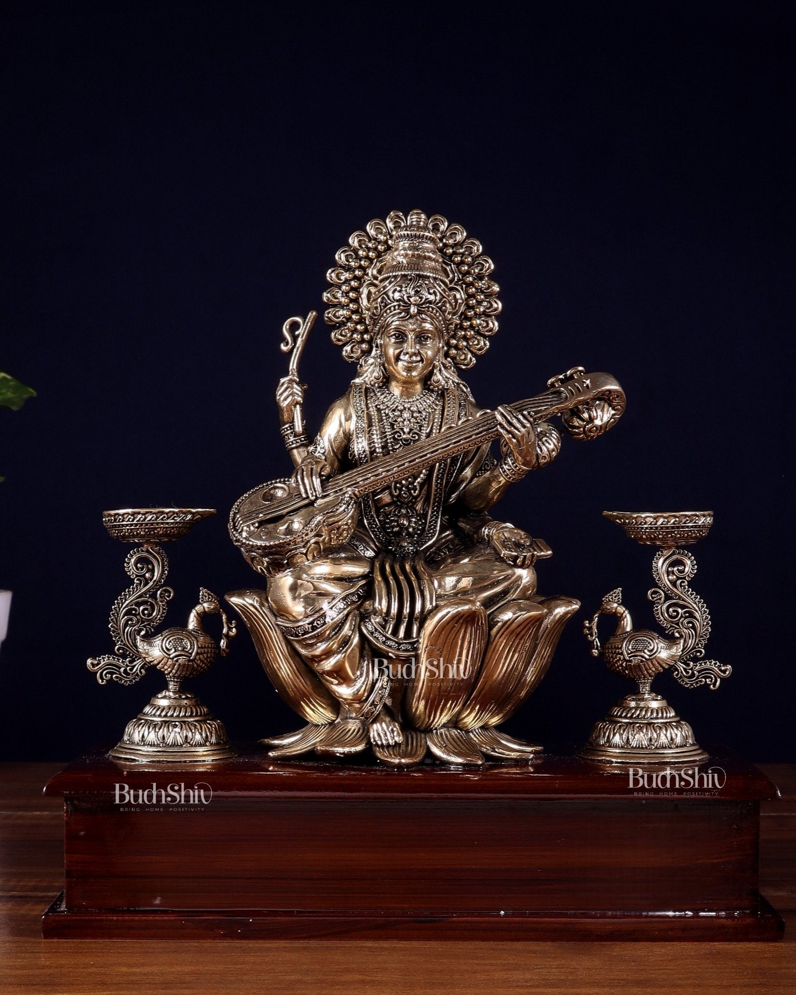 Brass Superfine Goddess Saraswati Idol with Twin Peacock Lamps on Wooden Base – 9.5 Inch - Budhshiv.com
