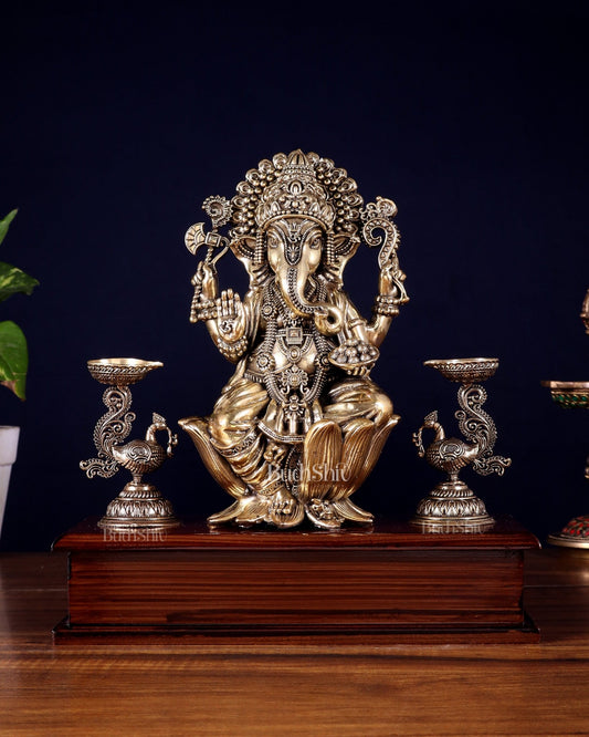 Brass Superfine Lord Ganesha Idol with Twin Peacock Lamps on Wooden Base – 9.5 Inch - Budhshiv.com