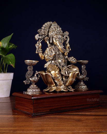 Brass Superfine Lord Ganesha Idol with Twin Peacock Lamps on Wooden Base – 9.5 Inch - Budhshiv.com