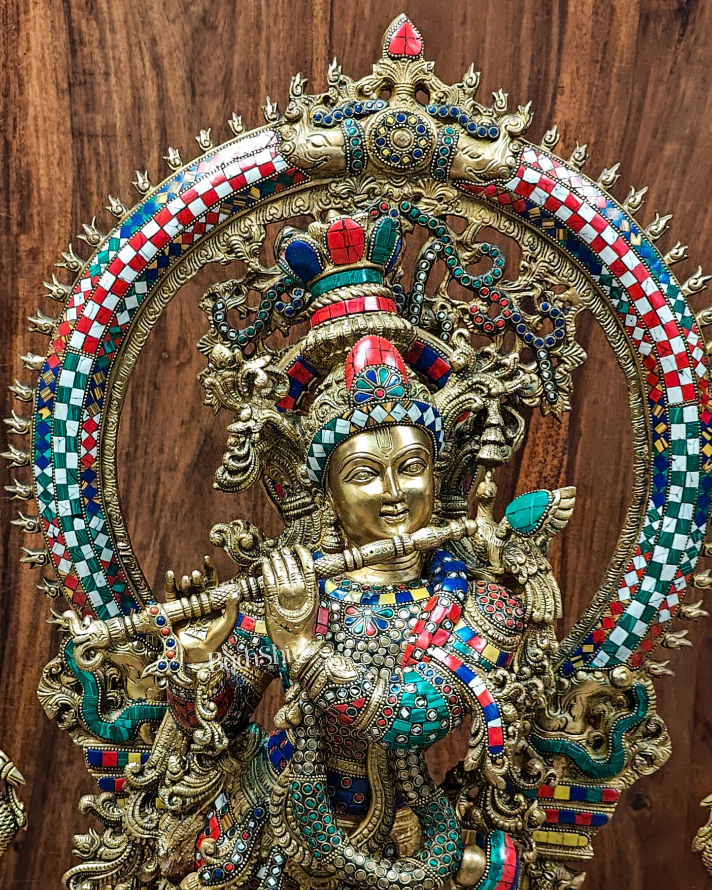 CLose up of Divine Superfine Brass Krishna Statue with Embossed Prabhavali Frame and Stonework 32 inch