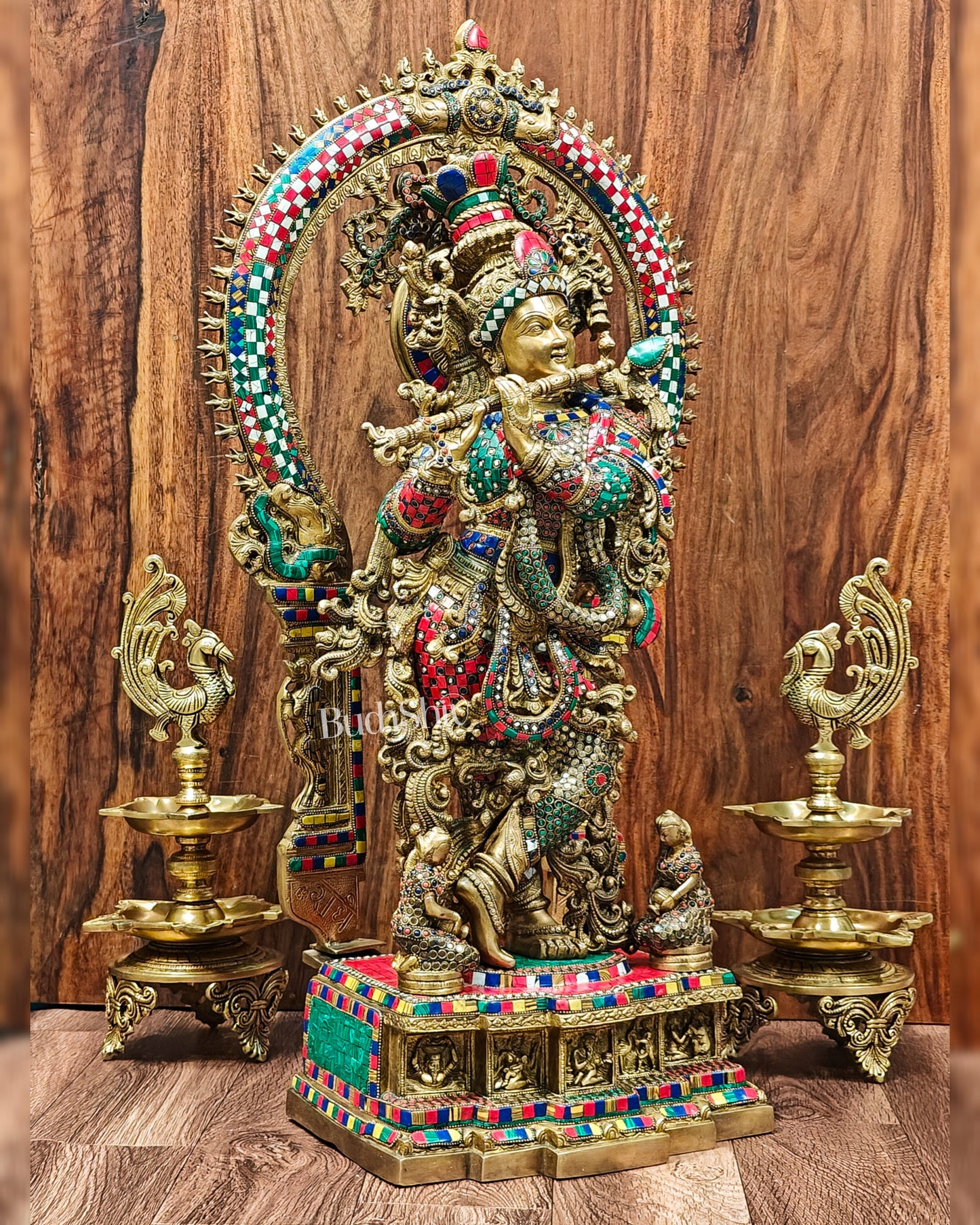 Side view of 32-inch tall Krishna Brass Statue with intricate stonework.