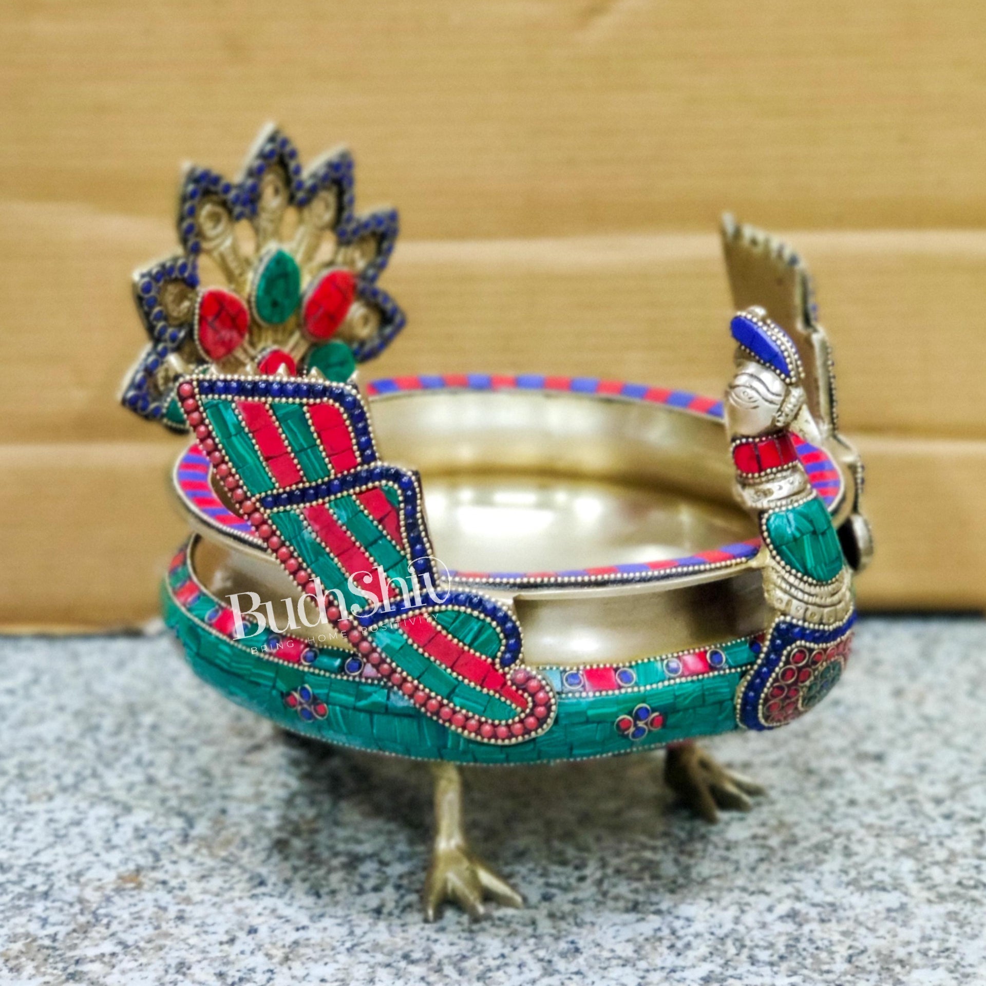 Brass peacock shaped urli with stonework - Budhshiv.com